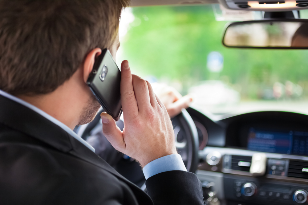 Man,Talking,On,The,Phone,While,Driving,His,Car